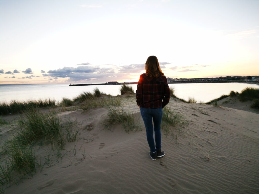 I was really worried about cyberbullying- ID: sarah looking out across the sea as the sun goes down