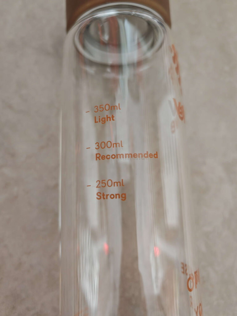 Glass bottle with volume markings: 350ml (Light), 300ml (Recommended), 250ml (Strong) for drink strength guidance.