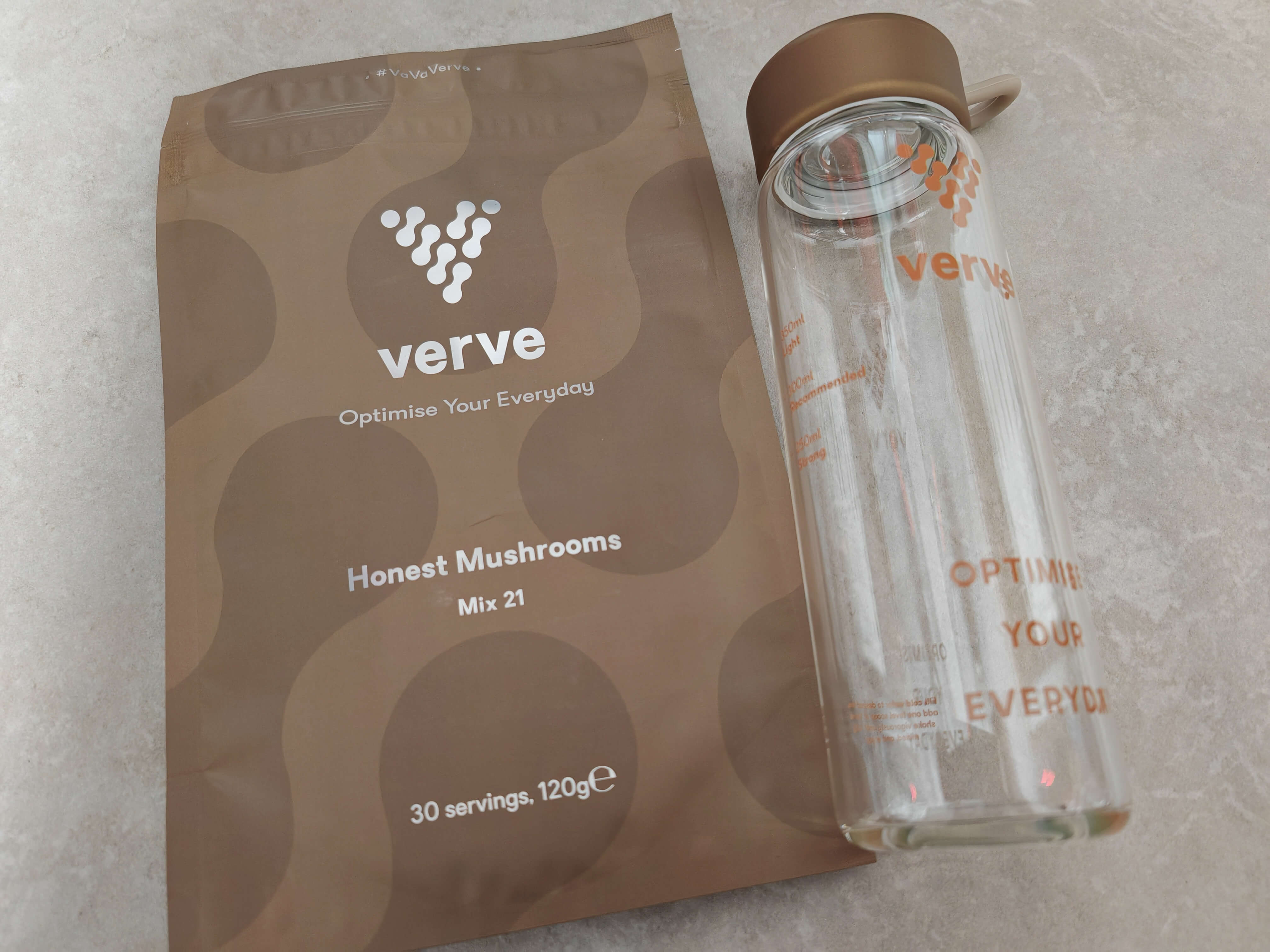 Verve Honest Mushrooms Mix 21 packaging with branded glass bottle on grey background.