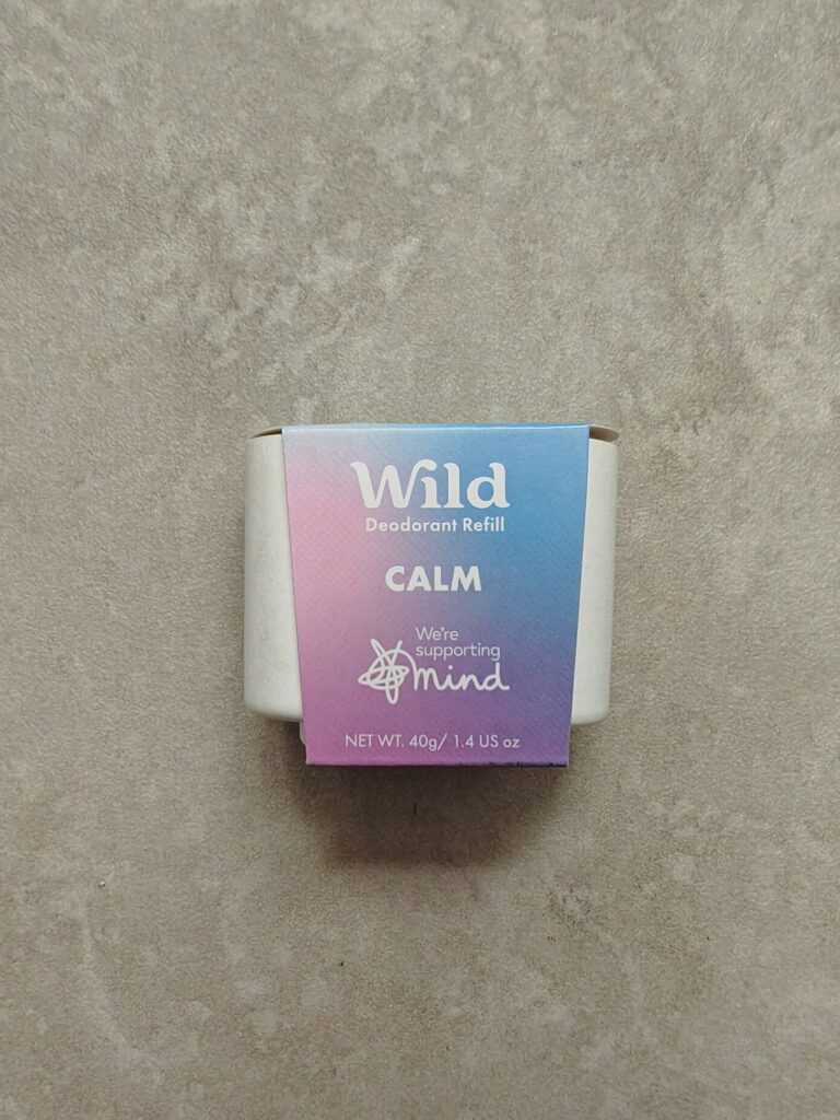 Wild deodorant refill in Calm scent, eco-friendly packaging on a textured surface.
