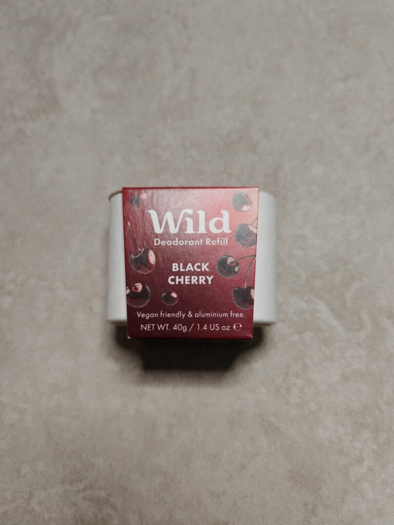 Wild deodorant refill in black cherry scent, vegan-friendly and aluminium-free, 40g packaging on beige surface.