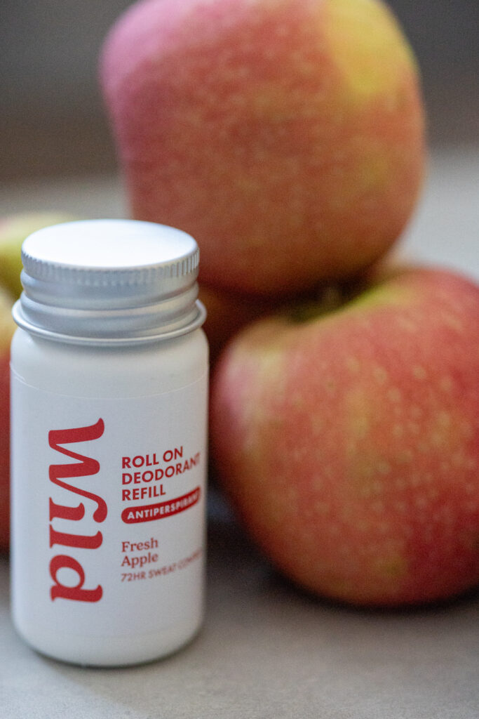 Roll-on deodorant refill with fresh apple scent beside apples. Eco-friendly 72-hour antiperspirant solution.