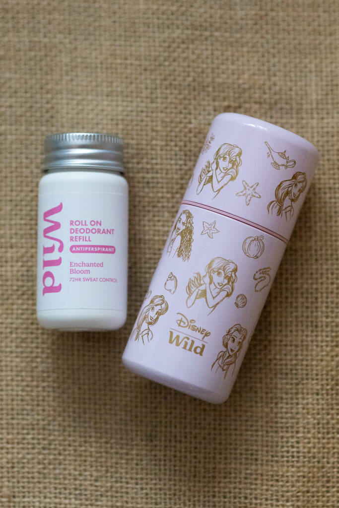 Wild deodorant with Disney-themed packaging on a textured surface. Eco-friendly roll-on antiperspirant.