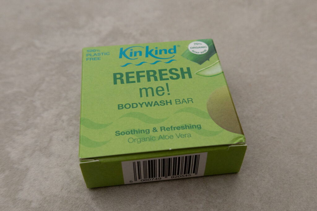 Green KinKind Refresh Me body wash bar with organic aloe vera, plastic-free packaging.