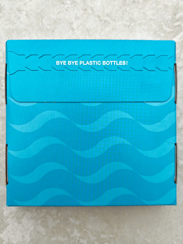 Blue eco-friendly packaging with Bye Bye Plastic Bottles! slogan, advocating sustainable living.
