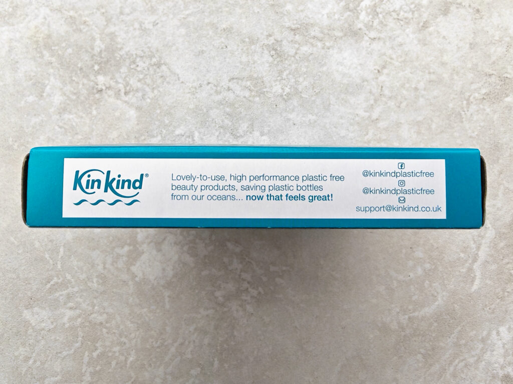 KinKind packaging with eco-friendly message promoting plastic-free beauty products, featuring contact details.