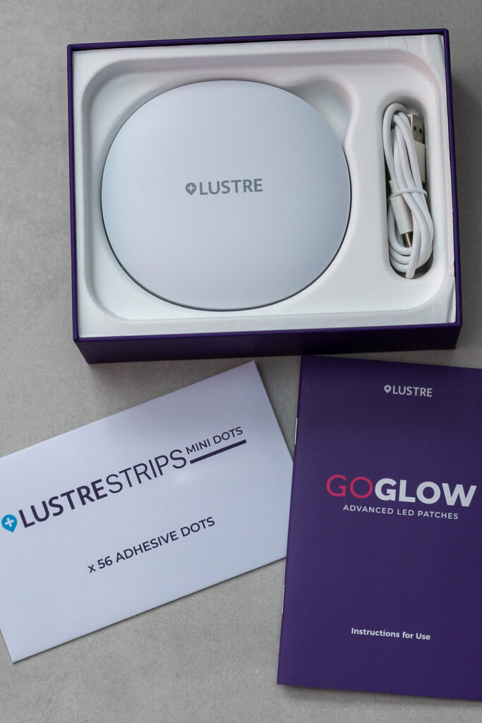 LUSTRE skincare LED patches and adhesive dots package with instructions on a table, ready to use.