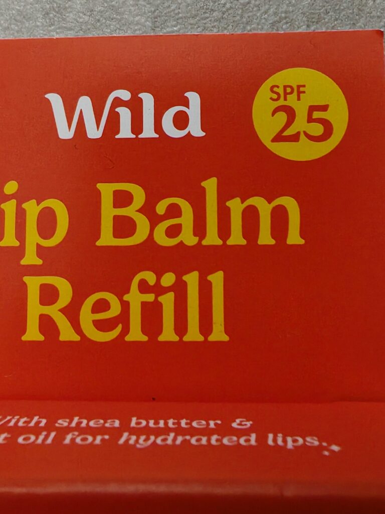 Wild lip balm refill packaging with SPF 25, enriched with shea butter and coconut oil for hydrated lips.